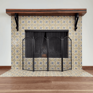 Beautiful fireplace decor featuring vibrant patterned tiles, a black mesh screen, and a sturdy wooden mantel, perfect for enhancing home warmth and style. Handcrafted fireplace with colorful tile surround and decorative fireplace screen, featuring wood mantel and black metal accents, perfect for living room home decor and enhancing home comfort and style.