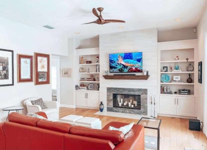 A spacious, stylish living room featuring a fireplace, built-in shelves, and contemporary decor, highlighting home renovation and interior design expertise by Days Home Solutions. Bright living room with modern fireplace, built-in shelving, and cozy furniture, showcasing home remodeling and interior design services by Days Home Solutions.