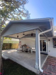 Expanded outdoor living space with a stylish covered patio featuring ceiling fans and lighting, enhancing home comfort and value. Perfect for relaxing or entertaining guests, this durable patio cover offers protection from elements while boosting the aesthetic appeal of your residence. Renewable energy patio cover, outdoor home improvement, covered porch with ceiling fans and lighting, Days Home Solutions.