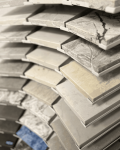 A wide array of marble, granite, quartz, and ceramic tile selections arranged for home renovation and remodeling purposes. Showcase of durable, stylish surfaces ideal for residential and commercial projects. Sample images of various natural stone and tile samples on display at a home renovation store. Perfect for exploring interior design, kitchen backsplash, bathroom tile, and flooring options.